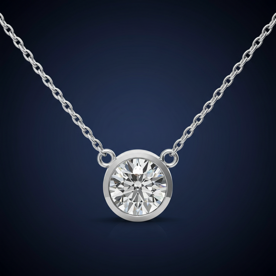 Round brilliant solitaire pendant necklace on a dark background showing sharp facet sparkle